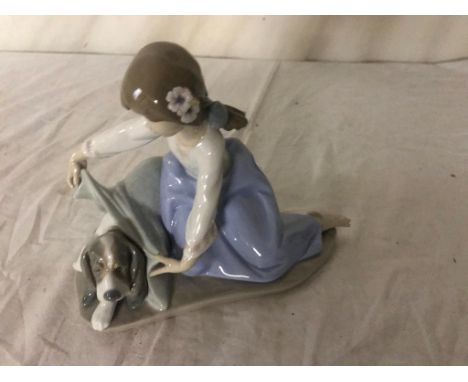 A Lladro figure (No 5688) of a girl covering her dog with a blanket