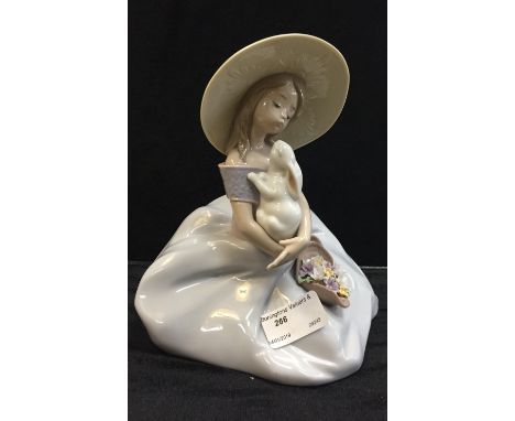 A Lladro girl with rabbit and flowers