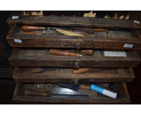 A vintage tool chest containing woodworking chisels and carving tools etc
