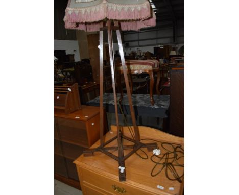 An early 20th Century oak framed standard lamp , of interesting design with adjustable height