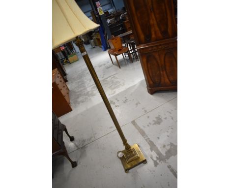 A reproduction brass effect standard lamp