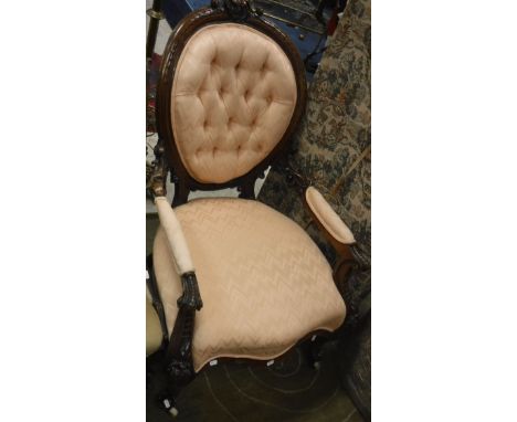 A Victorian carved walnut framed, button spoon back open arm salon elbow chair