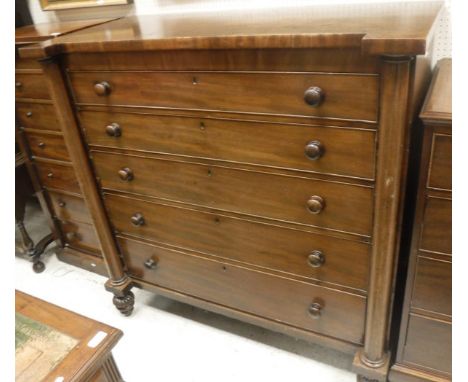 A 19th Century mahogany scotch type chest of five long graduated drawers flanked by turned side columns 