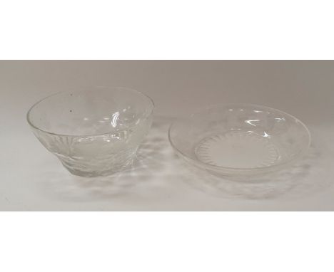 A set of cut glass bowls with engraved grape and vine decoration and matching saucers in the Waterford manner