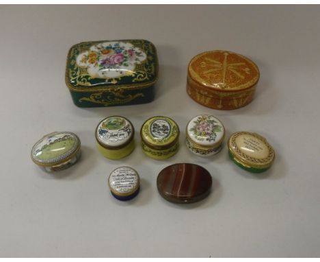 A French porcelain lidded box, the green ground highlighted with gilt decoration, the top set with floral decorated panel ins