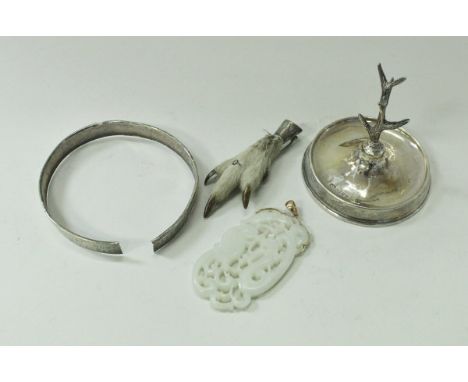A jade pierced pendant depicting bird and serpent in a foliate frame, together with a silver mounted bird's claw brooch, a si
