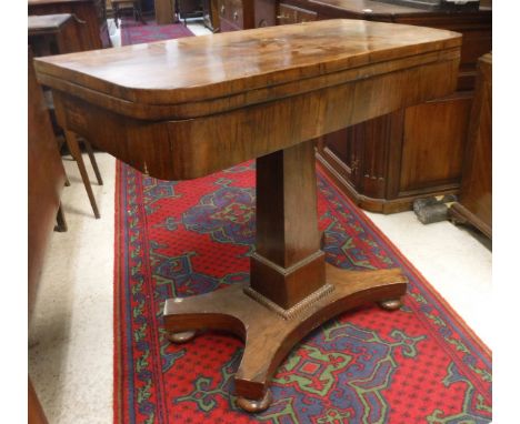A Victorian rosewood fold over card table on pedestal platform base