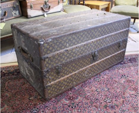 A Louis Vuitton cabin trunk with monogram print exterior, the cream cloth interior with stamped hangers and leather pulls to 