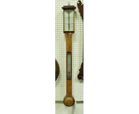A Victorian oak cased stick barometer with ivorine panels