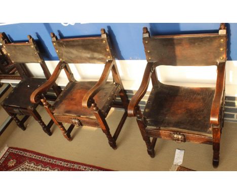 A set of 8 circa 1900 continental oak framed dining chairs in the Spanish taste, the backs with figural bust decoration and a