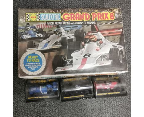 A Scalextric set with three extra cars.