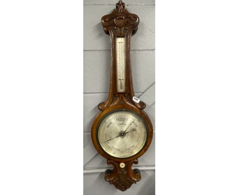 A carved walnut mercury barometer by R.Morrin, H. 100cm.
