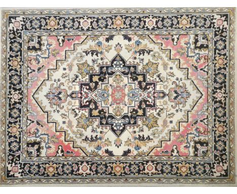 A vintage patterned machine woven rug, 230 x 170cm.