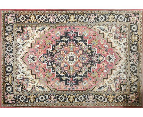 A vintage patterned machine woven rug, 282 x 200cm.