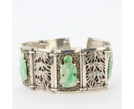 A 1920/30's silver (tested) Chinese bracelet set with carved jade figures of Lao Shou Xing, L. 17.5cm.