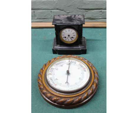 A late 19th Century black marble mantel clock plus a carved oak aneroid barometer