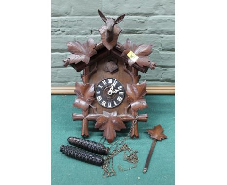 A Black Forest carved wooden cuckoo wall clock