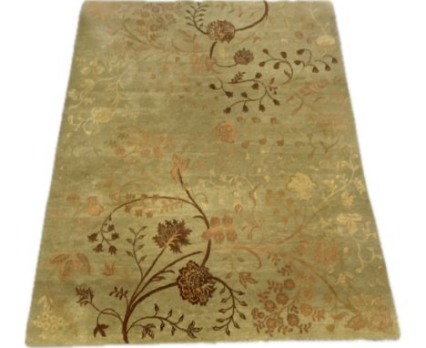 An Indian woollen deep pile carpet with scrolling foliate decoration. H.306 W.247cm