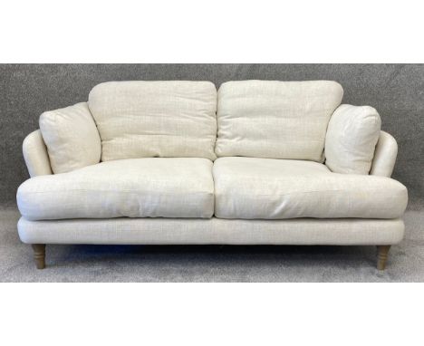 A contemporary oatmeal upholstered Loaf sofa with turned and limed oak feet and feather cushions. H.91 W.195 D.106cm