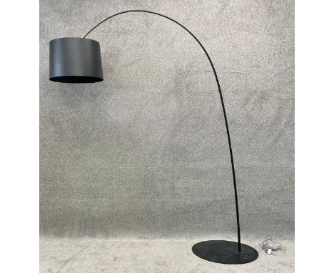 A large contemporary floor standing led arc lamp by Foscarini with a metal base and a black grained effect shade. H.208 W.182