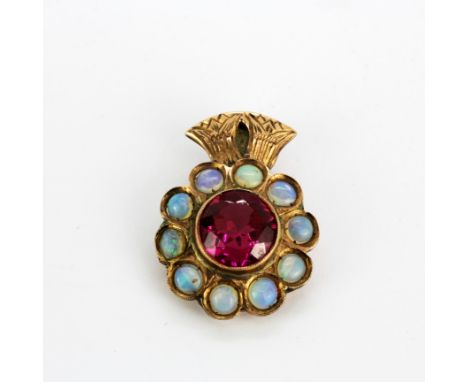 A yellow metal (tested minimum 9ct gold) pendant set with a large round cut synthetic ruby surrounded by cabochon opals, L. 2