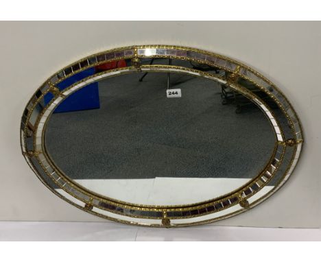 An oval gilt framed mirror, W. 80cm.