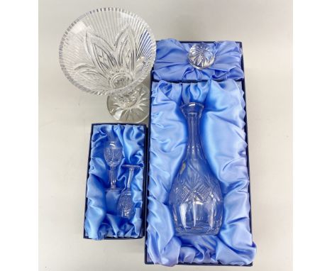 A boxed Waterford crystal decanter with two Waterford crystal sherry glasses and a Waterford vase.