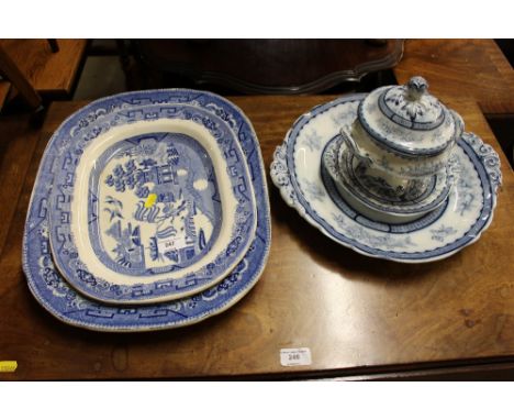 Two blue and white old willow patterned meat plates; a blue and white transfer printed sucrier on stand; and matching plate 