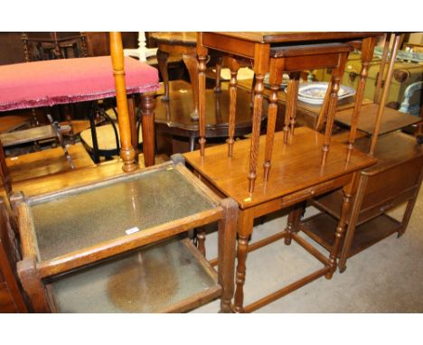 An oak and glass two tier tea trolley; a nest of two occasional tables; an oak side table; and a standard lamp