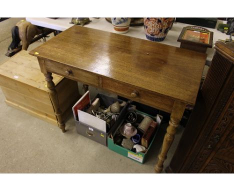 A mahogany two drawer side table raised on ring turned supports 