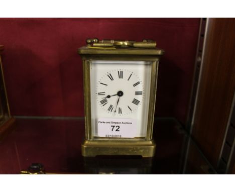 A brass cased carriage clock with key