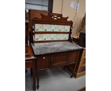 A Victorian mahogany marble top washstand having tile back