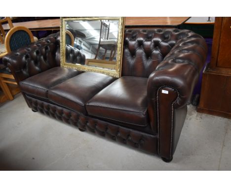 A vintage leather three seater chesterfield settee