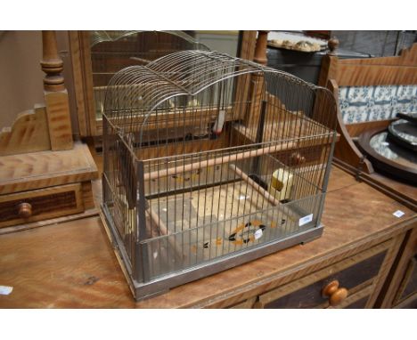 A vintage bird cage, labelled Genykage