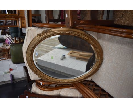 A vintage gilt oval wall mirror