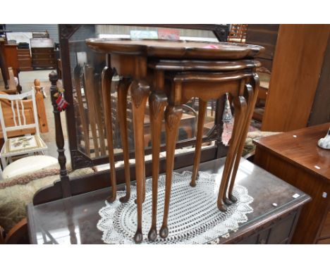 A vintage stained frame nest of tables having shaped top and cabriole legs