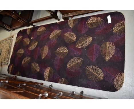 A vintage rug size carpet piece having rounded edges