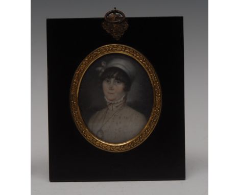 English School (early 19th century), portrait miniature, of a lady, bust-length, wearing a ribbon-tied mop cap above a curled