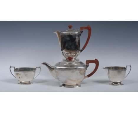 An Art Deco silver four piece tea service, comprising teapot, water pot, milk jug and sugar basin, angular scroll-capped hand