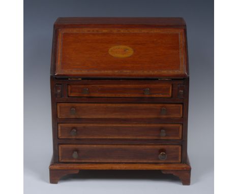 A George III style satinwood crossbanded mahogany miniature bureau, fall front inlaid with an oval shell patera, enclosing pi