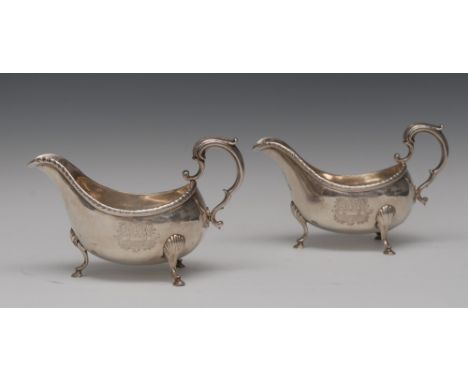 A pair of substantial Irish George III silver sauce boats, acanthus capped double scroll handles, gadrooned rims, hoof feet w