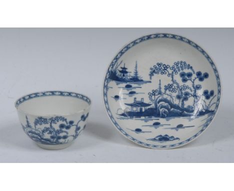 A Worcester Cannon Ball pattern tea bowl and saucer, printed in underglaze blue with pagoda, trees, rock work and cannon ball