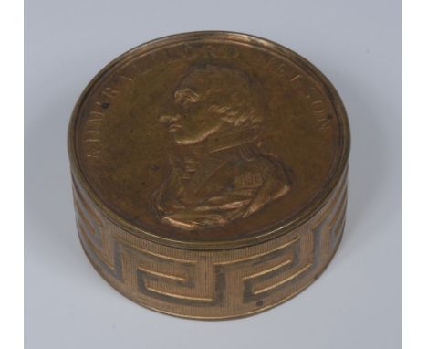 A 19th century circular gilt brass snuff box, the cover embossed bust of Admiral Lord Nelson, the sides with Greek key,  scri