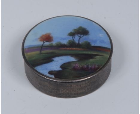 An early 20th century Continental silver circular box or bonbonniere, the push-fitting cover decorated in polychrome with a l