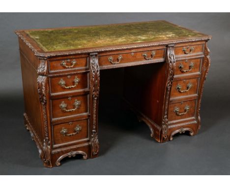 A Chippendale Revival mahogany canted rectangular desk, slightly oversailing top with inset tooled and gilt leather writing s