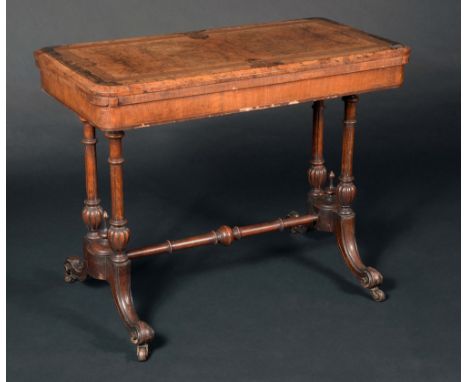 A Victorian walnut card table, quarter-veneered folding top outlined with boxwood stringing, enclosing a baize lined playing 