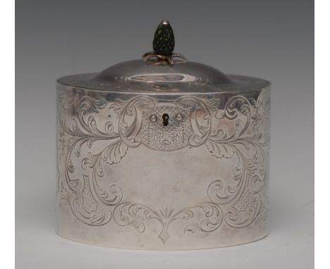 A George III silver oval tea caddy, hinged domed cover with green stained ivory pineapple finial, engraved in the Rococo tast