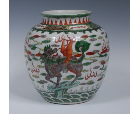 A Chinese ovoid vase, painted in the famille verte palette with fanciful beasts amongst scrolls and flames, 22cm high, four-c