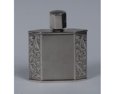 An Art Deco style silver lozenge shaped scent bottle, octagonal screw-fitting cover, engine turned sides flanked by canted an