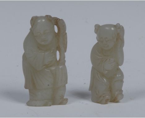 A Chinese pale celadon jade carving, of an elder, he stands, leaning on a staff, 6cm long; another, similar (2)